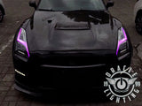 Black Nissan GT-R with pink headlight DRLs.