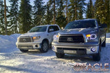 Toyota Tundra parked in the snow with white LED headlight halo rings installed.