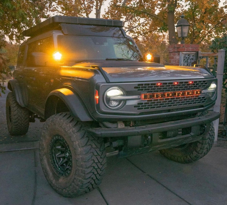 Grey Ford Bronco in a driveway with Amber LED Illuminated Letter Badges.