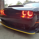 Front end of a black Dodge Challenger with red LED headlight halo rings installed.