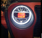 Close-up of a Jeep Wrangler headlight with amber "Demon Eye" Projector.