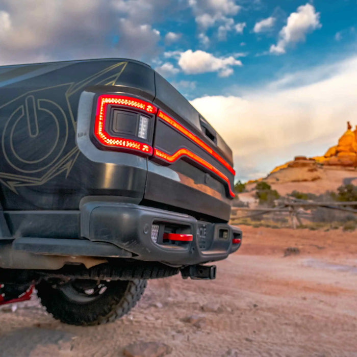 Side view of the rear end of a Jeep Gladiator with multiple LED lighting products installed, including Flush Mount Tail Lights and Racetrack LED Tailgate Panel.