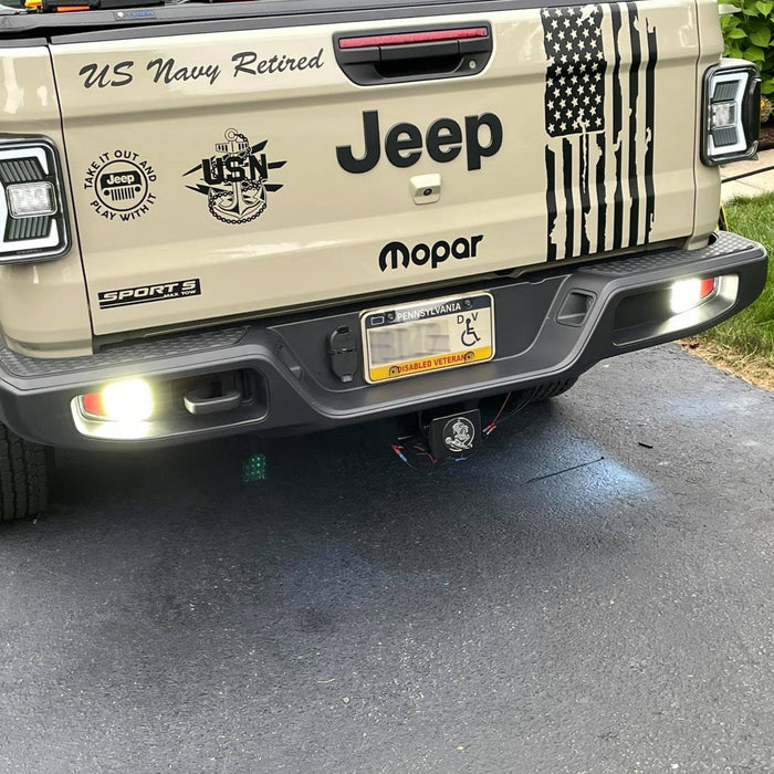 Rear end of a Jeep Gladiator with Rear Bumper LED Reverse Lights turned on.
