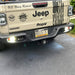 Rear end of a Jeep Gladiator with Rear Bumper LED Reverse Lights turned on.