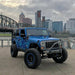 Three quarters view of a Jeep Wrangler with 7" High Powered LED Headlights installed.