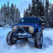Jeep Wrangler in the snow equipped with 7" High Powered LED Headlights.