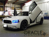 White charger in garage with butterfly doors and blue halo headlights.
