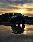 Nissan Titan with cyan LED headlight halo rings installed.