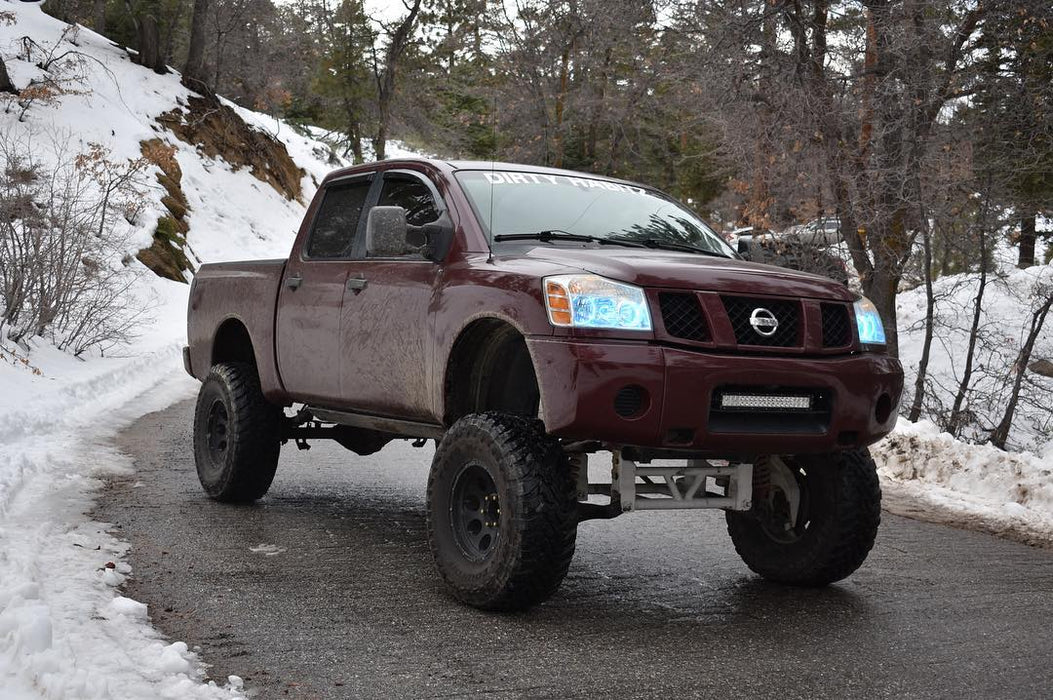 Three quarters view of a Nissan Titan with white LED headlight halo rings installed.