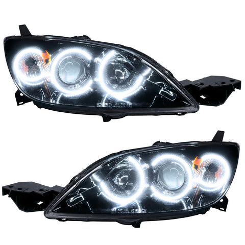 Mazda 3 headlights with white LED halo rings.