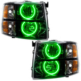 Chevrolet Silverado headlights with black housing and green LED halo rings.
