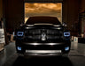 Front end of a RAM 1500 Sport with white headlight and fog light halos.