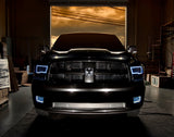 Front end of a RAM 1500 Sport with white headlight and fog light halos.