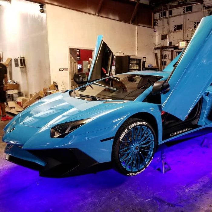 Blue Lamborghini with purple LED underbody kit.
