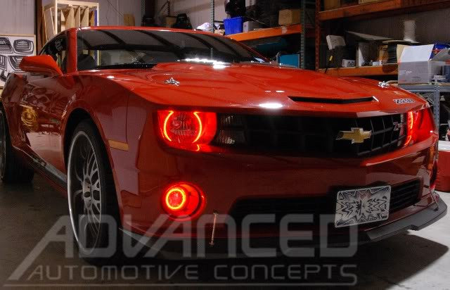 Three quarters view of a red Chevrolet Camaro with red LED headlight and fog light halo rings installed.