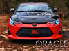 Front end of a Scion tC with cyan LED headlight halo rings installed.