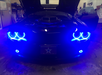 Dodge Challenger in garage with blue surface mount halos installed.