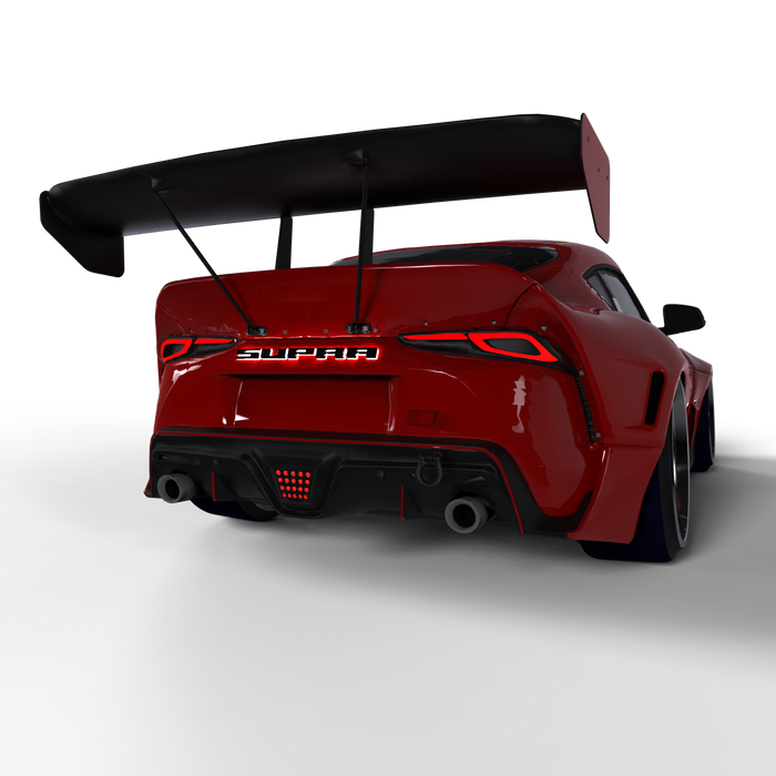 Rear view of a red Toyota Supra with Universal Illuminated LED Letter Badges installed above the license plate area.