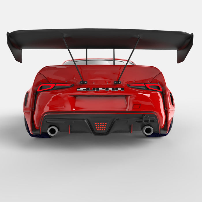 Rear view of a red Toyota Supra with Universal Illuminated LED Letter Badges installed above the license plate area.
