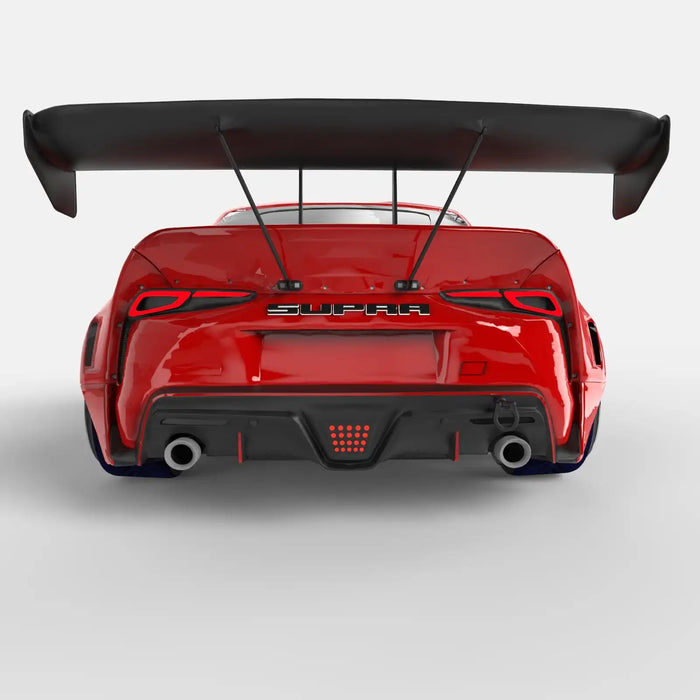 Rear view of a red Toyota Supra with Universal Illuminated LED Letter Badges installed above the license plate area.