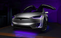 Silver Tesla Model X with purple headlight and fog light DRLs.