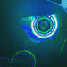 Close-up of an Oculus Headlight installed on a Jeep, with green outer halo ring, and blue inner halo ring.