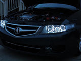 Front end of an Acura TSX with white LED headlight halo rings installed.