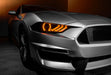 Close-up on a Ford Mustang headlight with amber halos and DRLs.