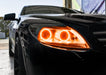 Close-up on the headlight of a Mercedes Benz CL 500 with amber LED halo rings.