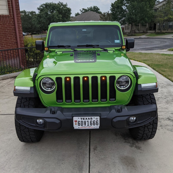 Front end of a Jeep Wrangler JL with amber Pre-Runner Style LED Grill Light Kit installed.