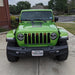 Front end of a Jeep Wrangler JL with amber Pre-Runner Style LED Grill Light Kit installed.