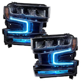 Chevrolet Silverado 1500 headlights with cyan DRLs.