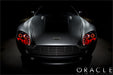 Front view of an Aston Martin Vantage with red LED headlight halo rings installed.