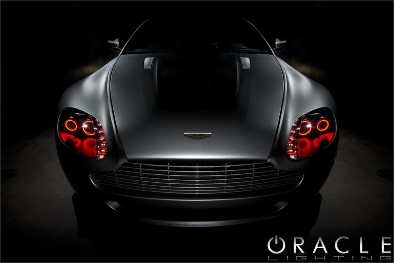 Front view of an Aston Martin Vantage with red LED headlight halo rings installed.