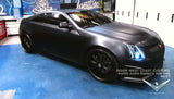 Three quarters view of a Cadillac CTS-V Coupe with white LED headlight halo rings installed.