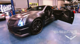 Three quarters view of a Cadillac CTS-V Coupe with white LED headlight halo rings installed.