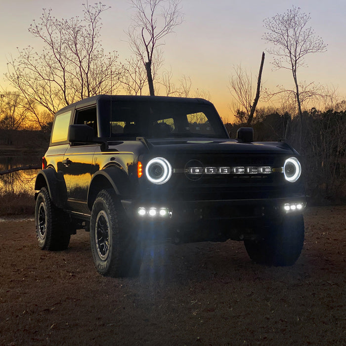 Ford Bronco outside with headlights and fog lights on