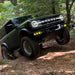 Green Ford Bronco trail riding with yellow Triple LED Fog Lights.