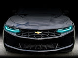 Front end of a Chevrolet Camaro with aqua headlight DRLs.