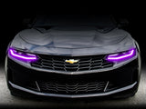 Front end of a Chevrolet Camaro with pink headlight DRLs.