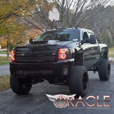 Three quarters view of a Chevrolet Silverado with amber LED headlight halo rings installed.