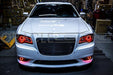 Front end of a Chrysler with red LED headlight and fog light halo rings.