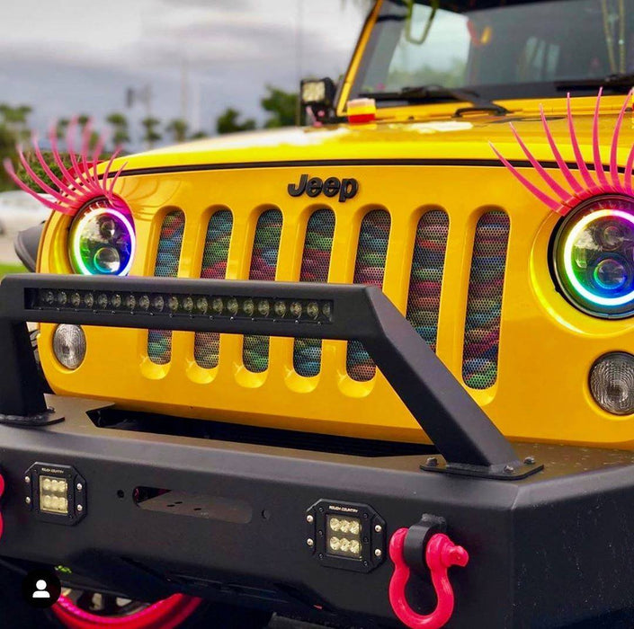 Front end of a Jeep Wrangler with Dynamic ColorSHIFT 7" High Powered LED Headlights installed.
