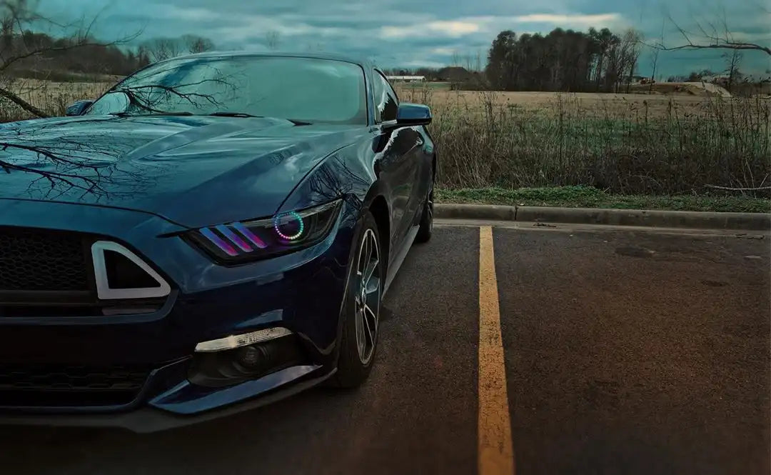Close-up of a Ford Mustang headlight with rainbow halos and DRLs.