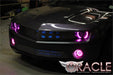 Front end of a Chevrolet Camaro with pink LED headlight and fog light halo rings installed.