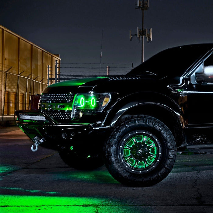 Black and green Ford Raptor with green LED lighting installed.