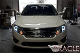 Front end of a Ford Fusion with white LED headlight halo rings.