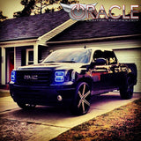 Three quarters view of a GMC Sierra with blue LED headlight halo rings.