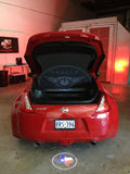 Rear end of a Nissan 370Z with GOBO Projectors installed, showing the Texas flag.