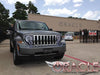 Three quarters view of a Jeep Liberty with white LED headlight halo rings installed.